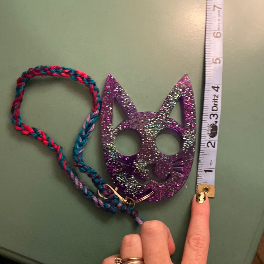 Purple resin self defense cat keychain with glow in the dark and teal glass